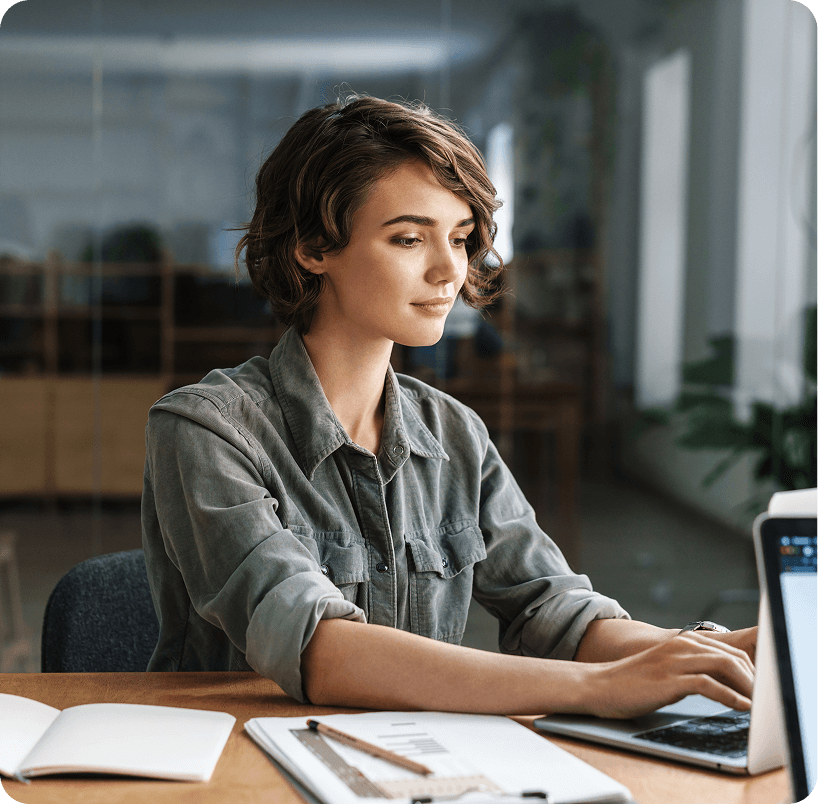A fund administration professional working at her laptop
